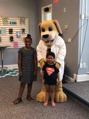 Dog In in a Medical Coat with Two Children