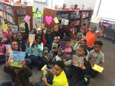 Children Holding up Books