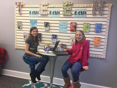 Two Girls with Laptops at table together